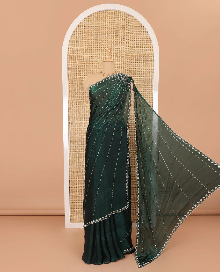 Green micro-stone work fendy chiffon saree with paisley stone work on its shoulder, a scallop stone work border, a butterfly style pallu, and a matching stone work blouse