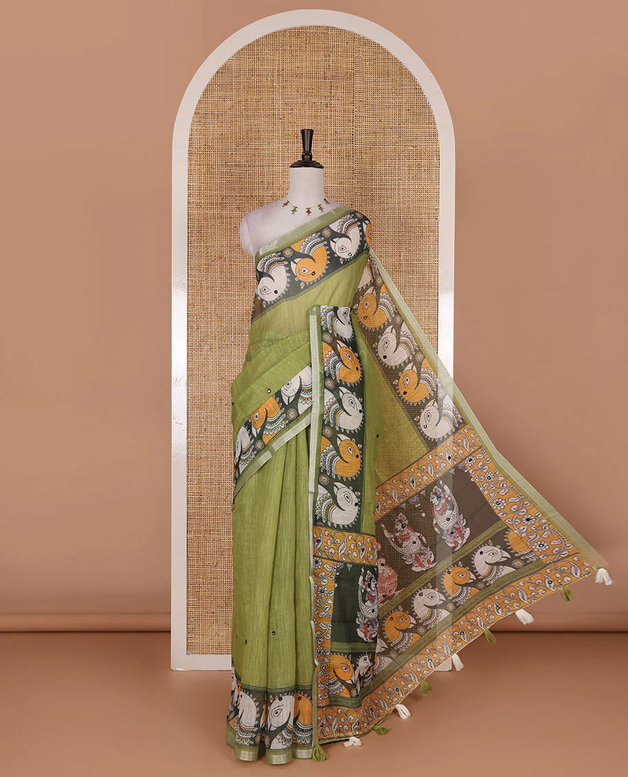 Green mirror thread embroidered linen saree, contrast kalamkari peacock printed border, pallu of kalamkari peacock and human figurines print, and printed blouse