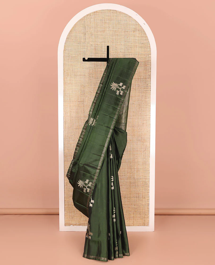 Green pichwai cow motifs Mayuri soft silk saree, zari piping border, and pallu of geometric designs