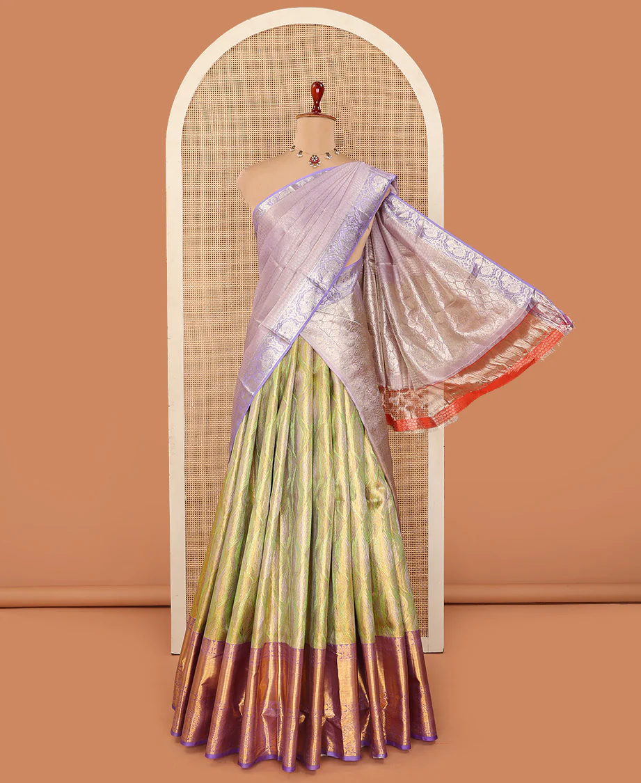 Green Pure Silk Half-Saree Meticulously Crafted with Jacquard Weave on Its Skirt, Complemented by a Contrast Border Featuring Thilakam Mokku, Annam, Chakram, and Yaali Designs, Comes with a Contrast Blouse and a Dhavani of Intricate Zari Designs