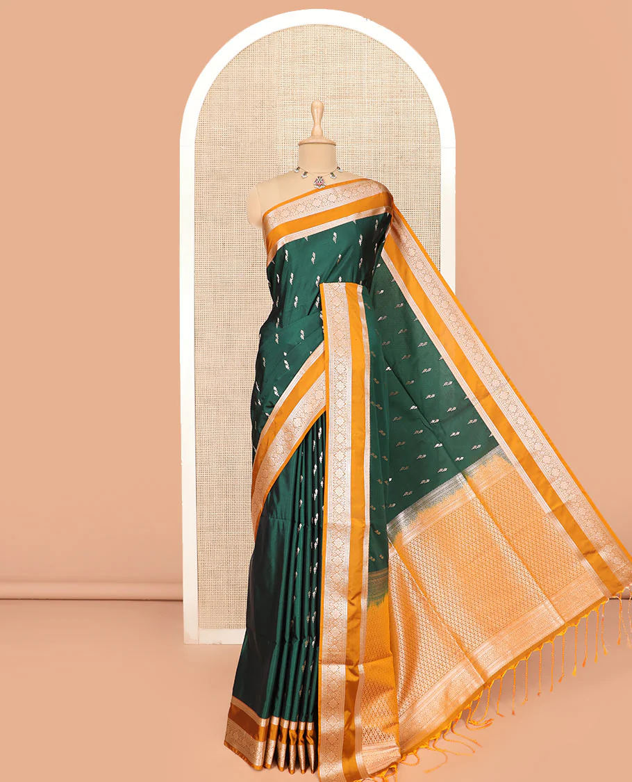 Green Semi-Soft Silk Saree Adorned with Floral Bud Motifs Woven Across Its Body, Complemented by a Contrast Rettai Pettu Traditional Zari Border, Grandly Woven Pallu of Jaal Designs, and Paired with a Contrast Blouse