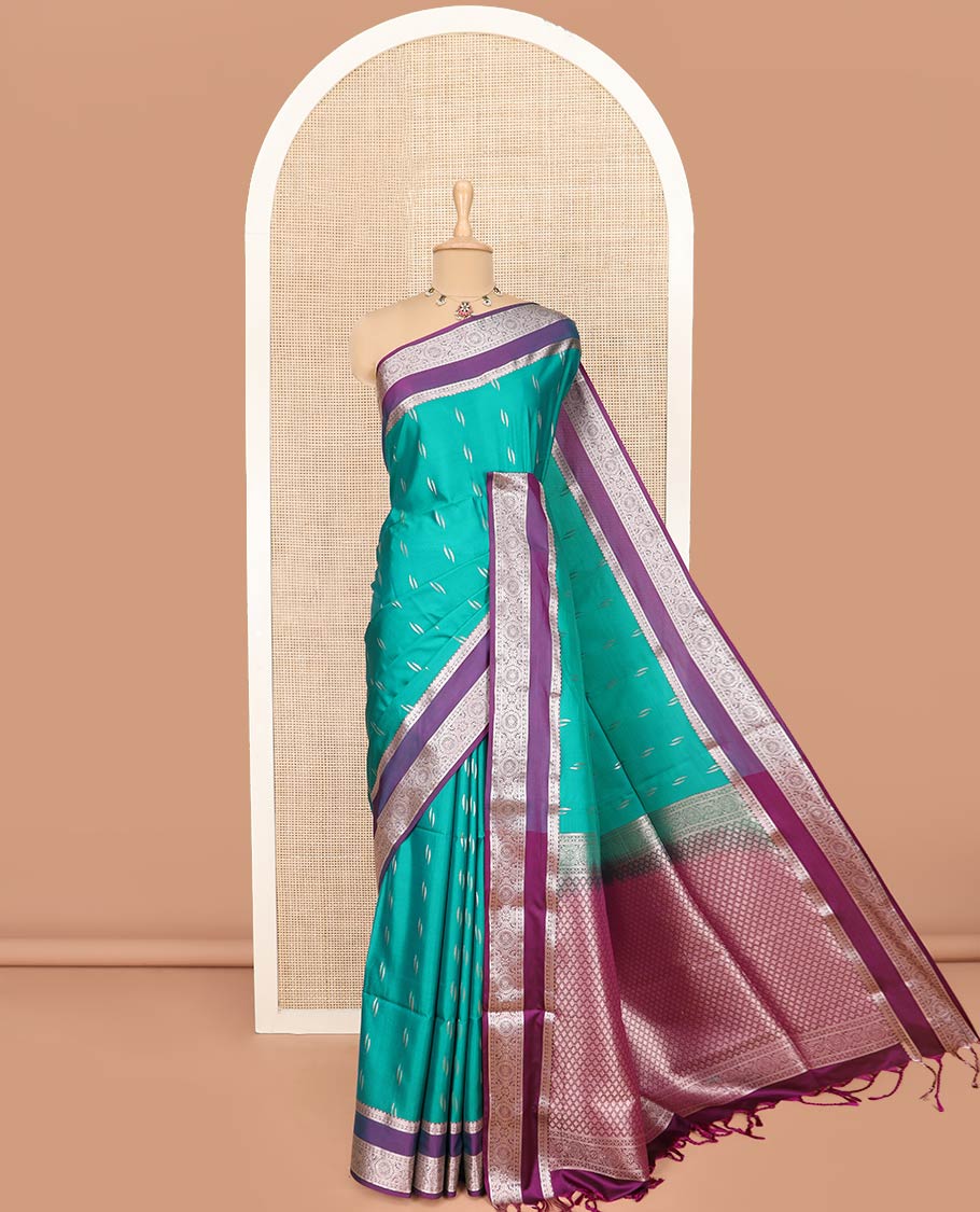 Green Semi-Soft Silk Saree Detailed with Zari Buttas All Over Its Body, Complemented by Contrast Traditional Zari Design Rettai Pettu Border, Pallu Enriched with Jaal Design, and Paired with a Contrast Blouse