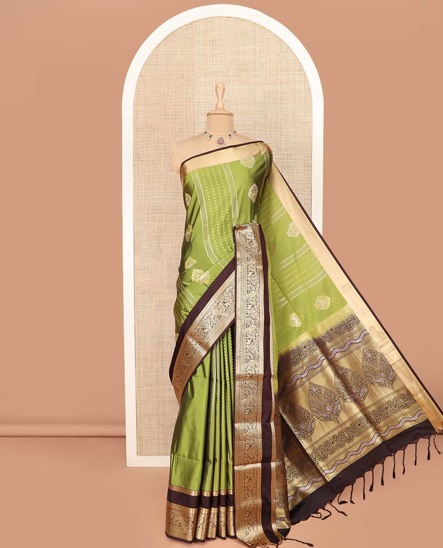 Green Semi-Soft Silk Saree Elevated with Intricate Designs Woven All Over Its Body, Complemented by Contrast Traditional Zari Design Rettai Pettu Border, Opulently Embellished Pallu of Intricate Zari Designs, and Paired with a Contrast Blouse
