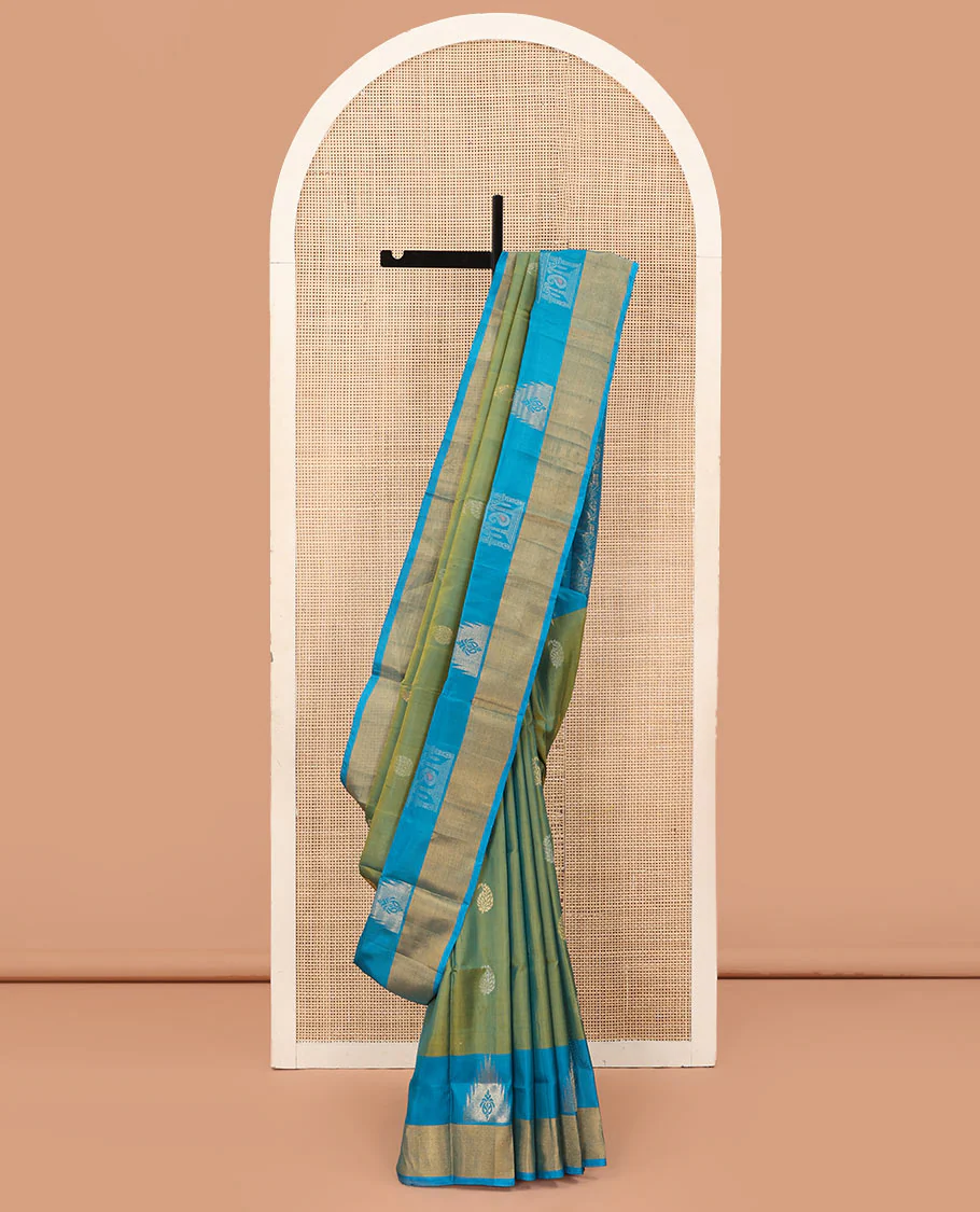 Green Uppada Silk Saree Beautified with Paisley Buttas, Subtle Contrast Border of Temple Gopuram Motifs, Captivating Pallu Featuring Floral Jaal Design, and Paired with a Contrast Blouse