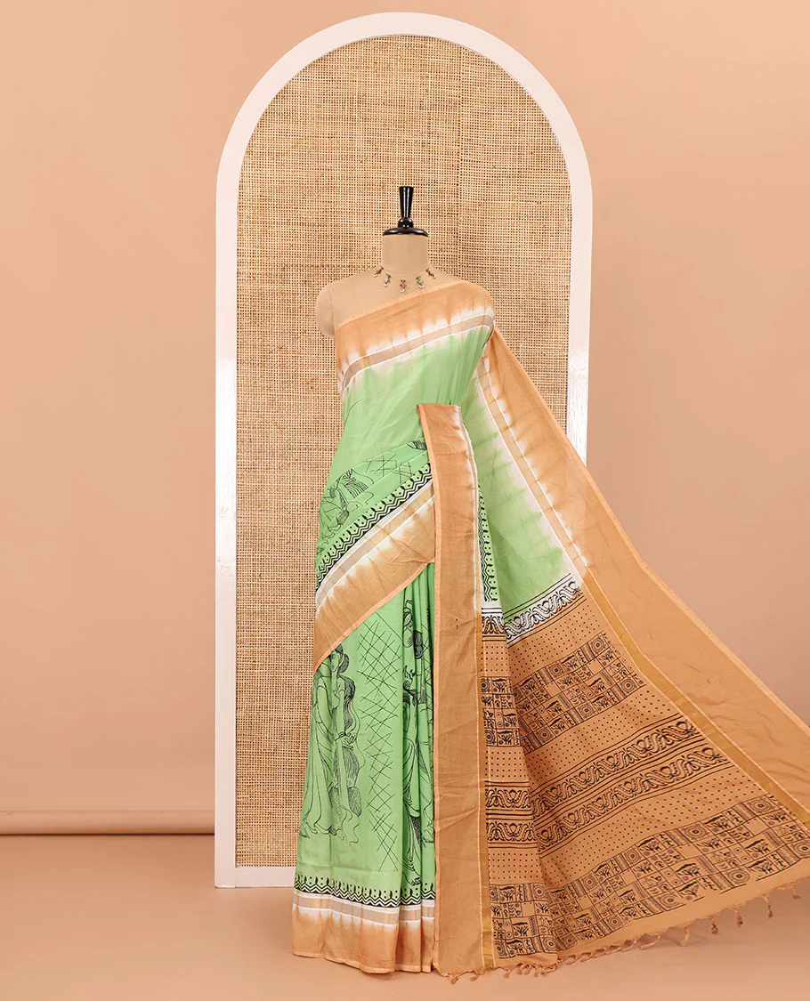 Green South Indian women motifs printed chennur silk saree, contrast plain border, printed pallu, and a contrast plain blouse
