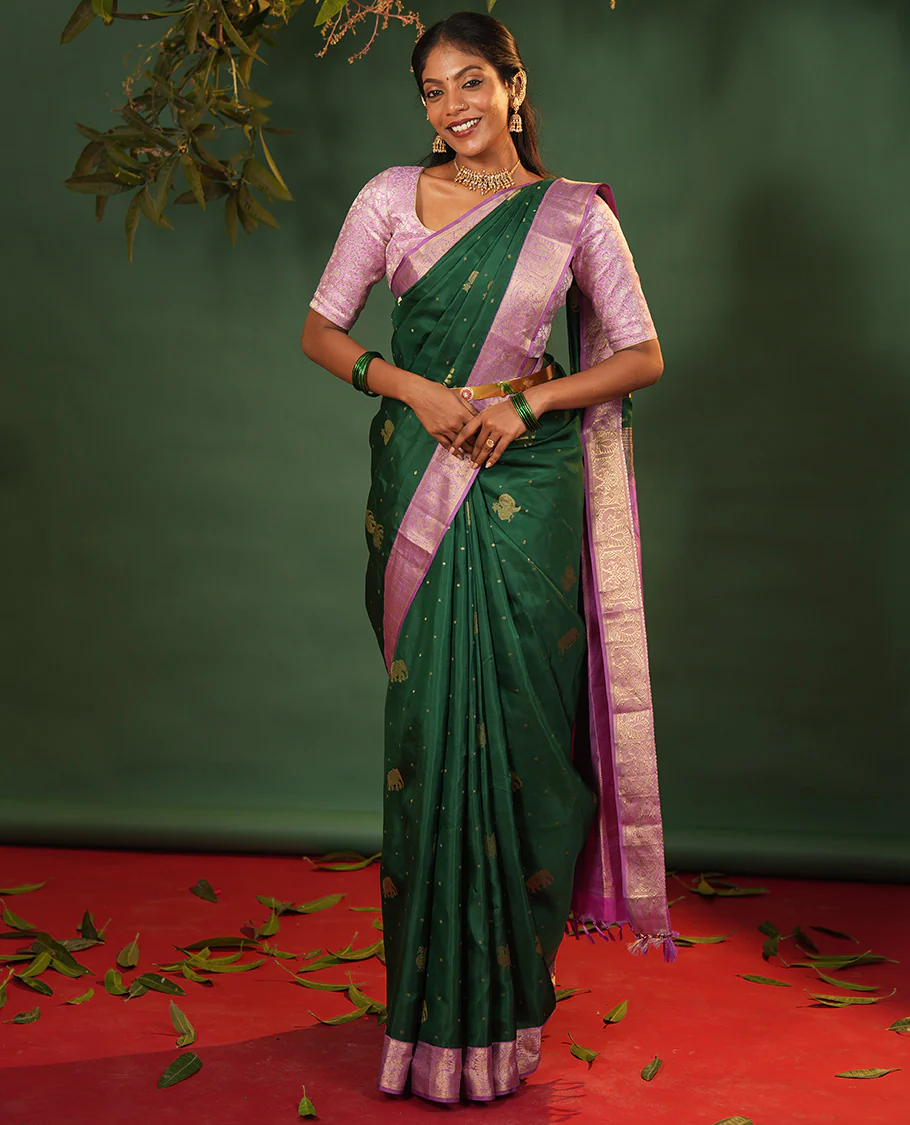 Green yaanai and mayil buttas Vasundhara silk saree, contrast border of muthu, kathir, mayil, and yaanai designs, and diagonal striped pallu