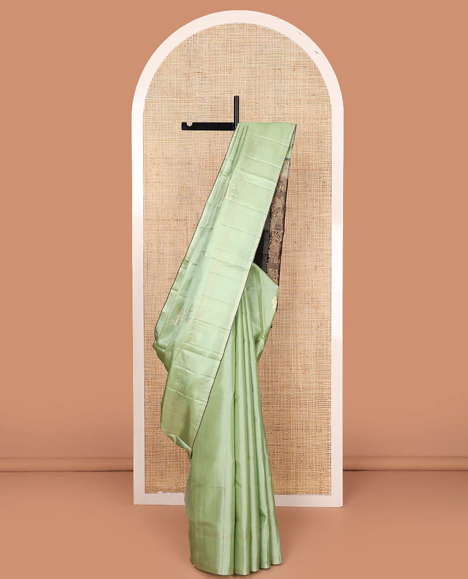 Green yaanai buttas Mayuri soft silk saree, zari striped border, and contrast yaanai and house motifs woven pallu