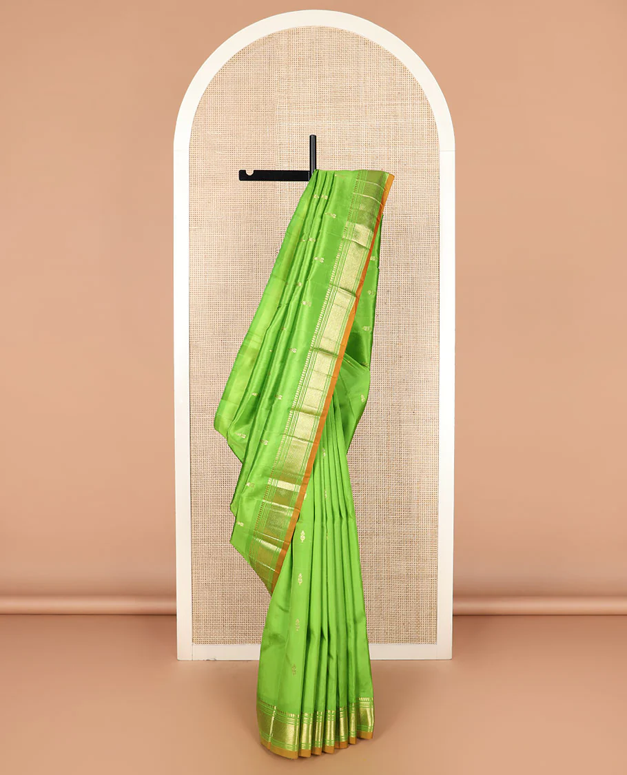 Green zari buttas Kanchipuram silk saree, zari border of paneer sombu, banaras, muthu, and jaal designs, and zari design pallu