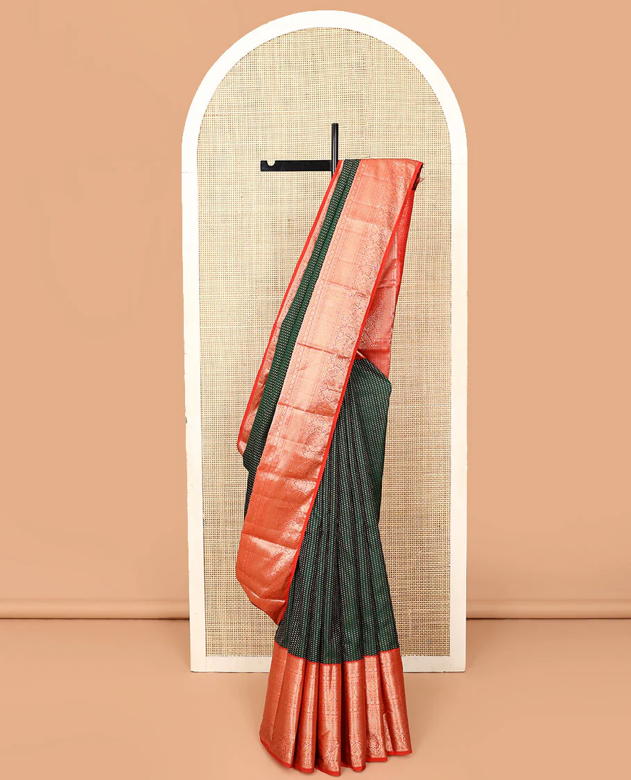 Green zari buttas Vasundhara silk saree, contrast border of rekku, kathir, diamond, laddu kamalam, neli, chakram, kuyil kann, mayil, and yaanai designs, and jaal pallu
