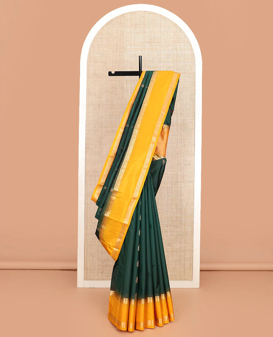 Green zari buttas Vasundhara silk saree, contrast rettai pettu border of rekku, muthu, and diamond designs, and jaal pallu