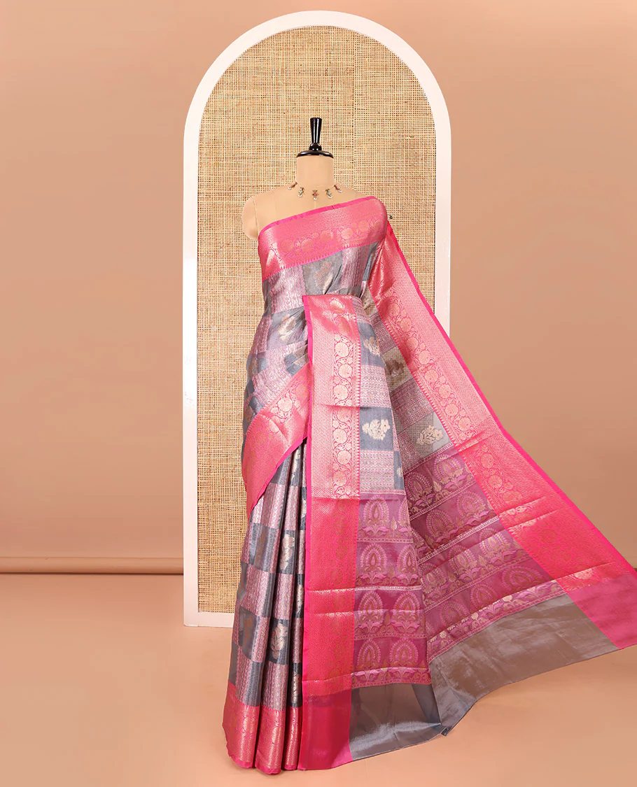 Grey and pink floral and geometric patterns tissue silk saree, contrast traditional zari border of floral creeper designs, intricate pallu, and a jacquard blouse
