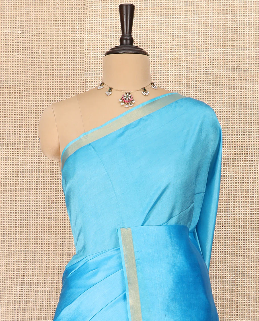 Light Blue Plain Banana Pith Saree Subtly Sparkled with Zari Bavanji Border, Gleaming Zari Stripes Woven Pallu, and Paired with a Matching Plain Blouse - Image 2