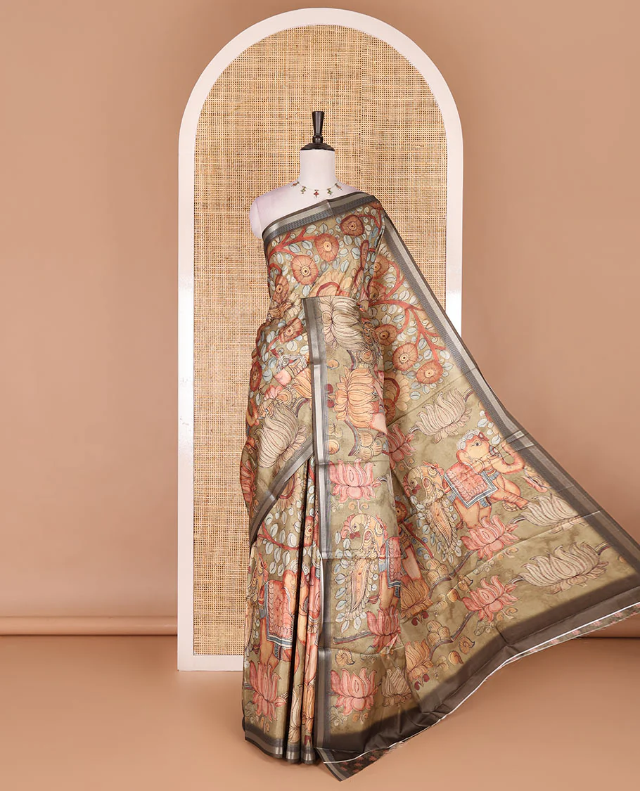Light green kalamkari elephant, peacock, and floral printed semi-tussar saree, zari piping border, kalamkari motifs printed pallu, and contrast printed blouse