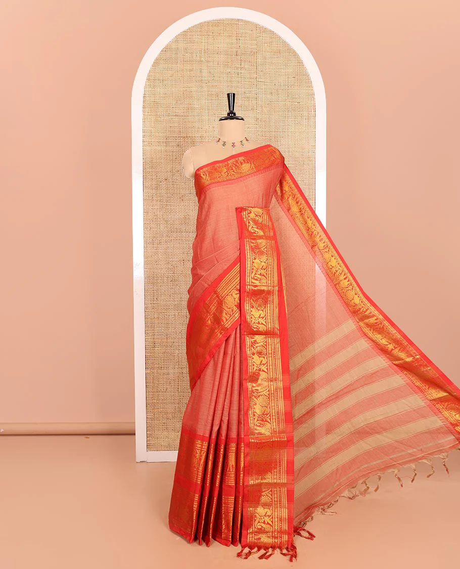 Light Rust Orange Plain Mercerised Cotton Saree Highlighted with a Contrasting Rettai Pettu Border Featuring Peacock and Elephant Motifs in Zari, a Subtly Striped Pallu, and a Matching Blouse