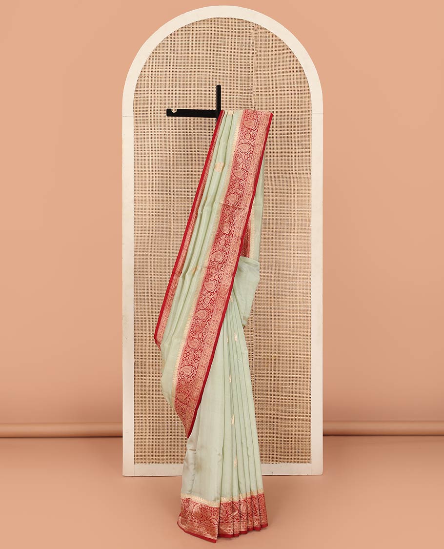 Light Sandal Raw Mango Silk Saree Beautified with Buttas, Featuring a Contrast Paisley Zari-Designed Border, a Zari-Elevated Jaal Pallu, Paired with a Contrast Blouse