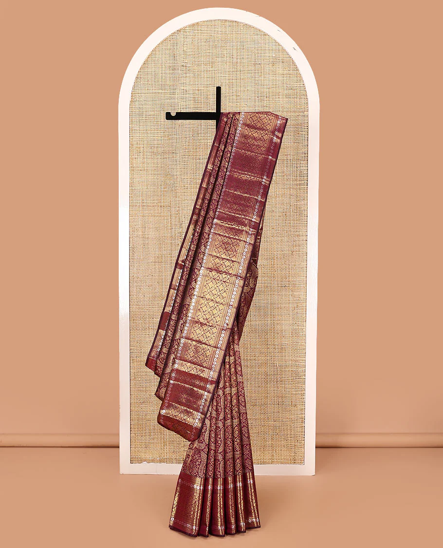 Maroon jacquard kanchipuram silk saree, zari border of thilakam mokku, kodi visiry, and jaal designs, and jaal pallu