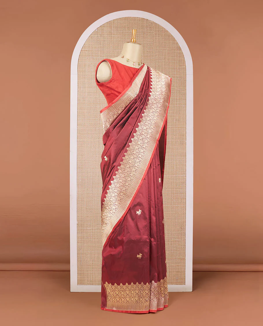 Maroon katan silk saree with patola-style zari buttas, zari border & pallu of patola-style animal motifs enclosed checks