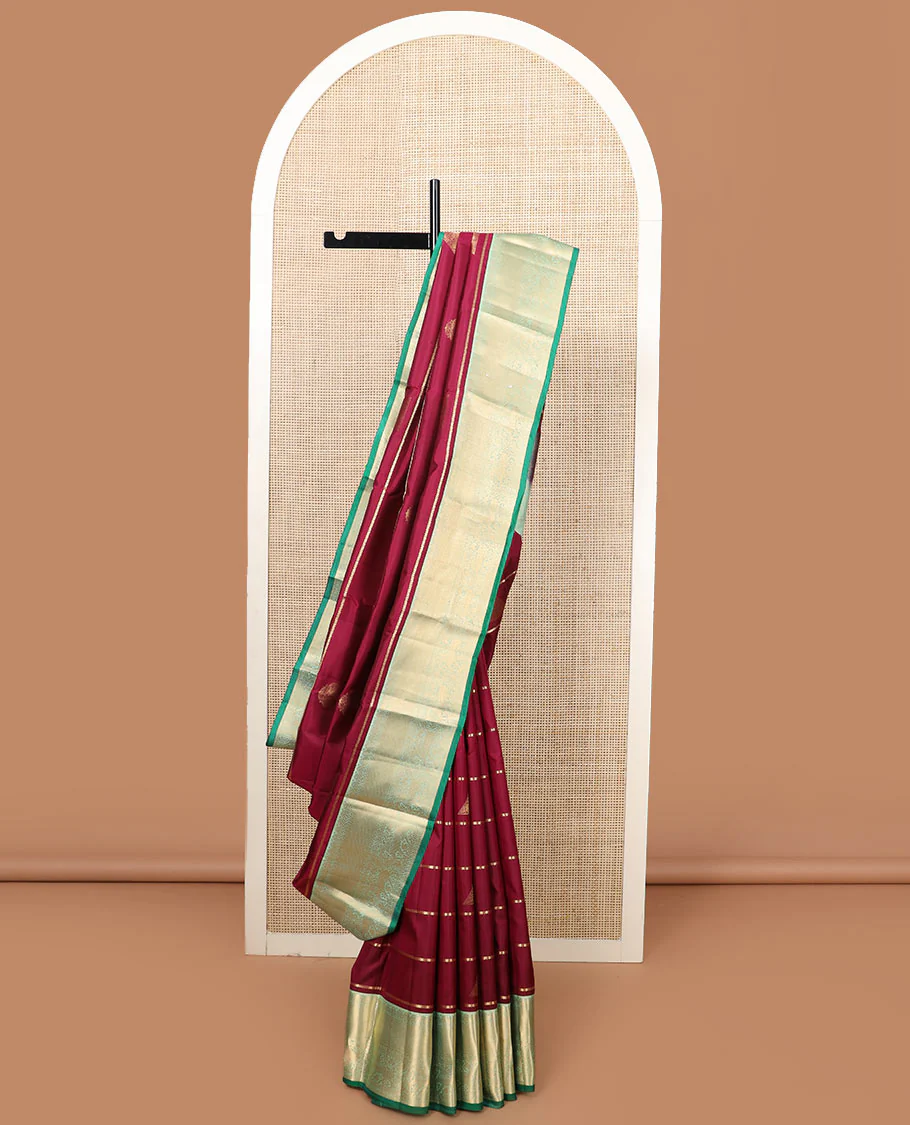 Maroon zari buttas Vasundhara silk saree, contrast border of yaali designs, and pallu of diagonal stripes