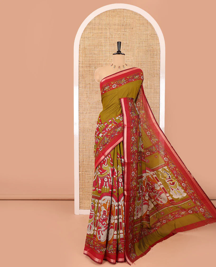 Mehendi green human figurines printed muslin cotton saree, contrast floral-peacock printed border of piping work, kalamkari printed pallu, and a contrast blouse of flower motifs print