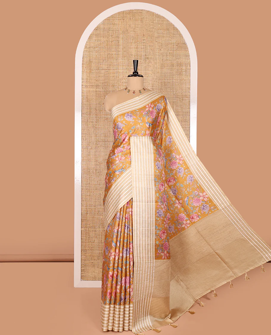 Mustard colorful floral motifs printed fancy tussar saree, contrast triangle motifs border, striped pallu, and a contrast striped blouse
