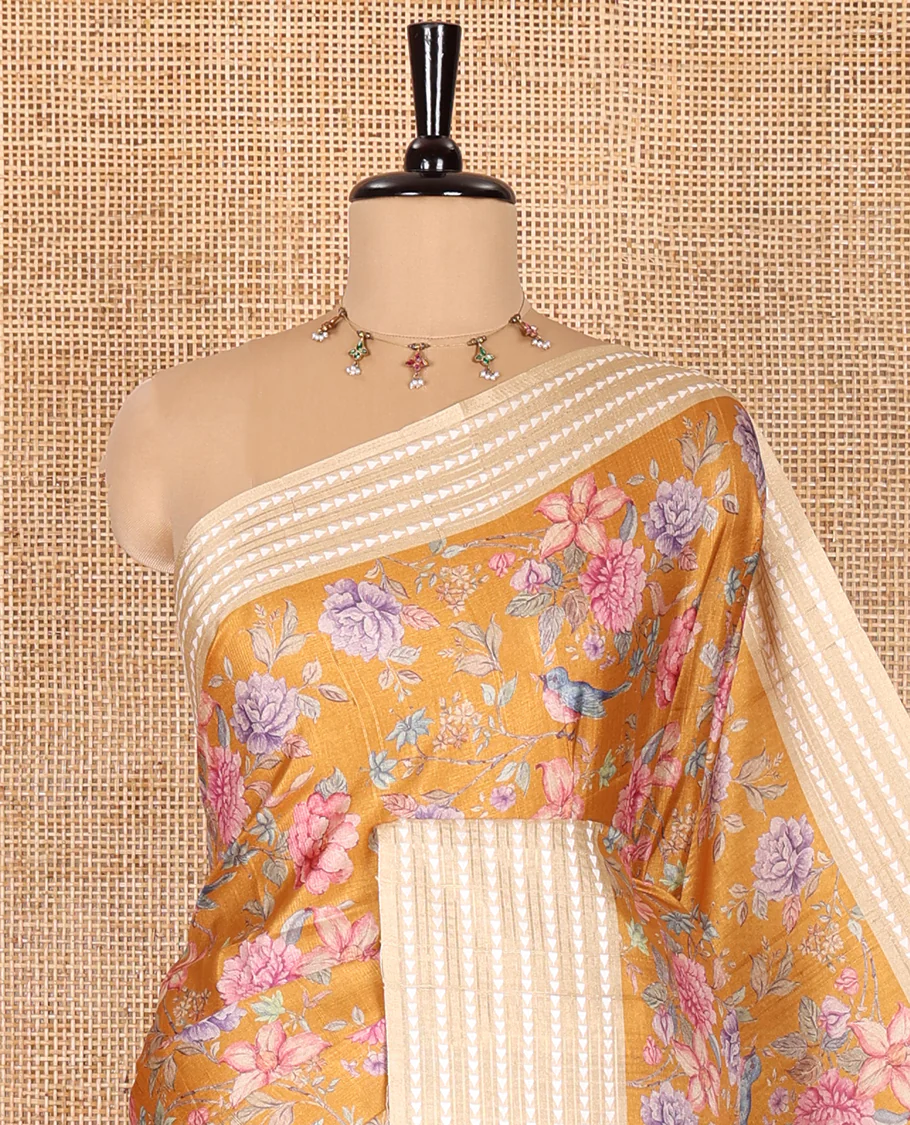 Mustard colorful floral motifs printed fancy tussar saree, contrast triangle motifs border, striped pallu, and a contrast striped blouse - Image 2