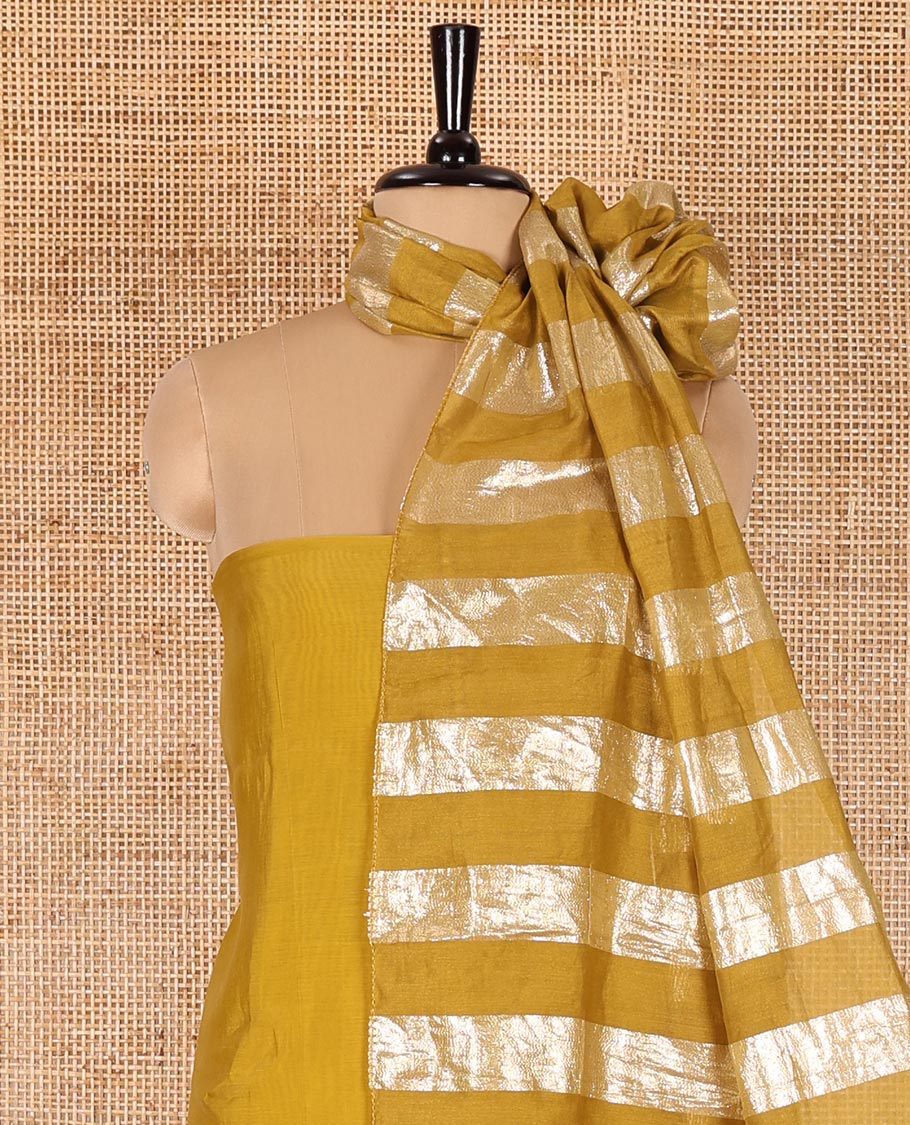 Mustard material chudidar set, plain with pom-pom tasseled mul chanderi top, a matching bottom, and organza dupatta of stripes - Image 4