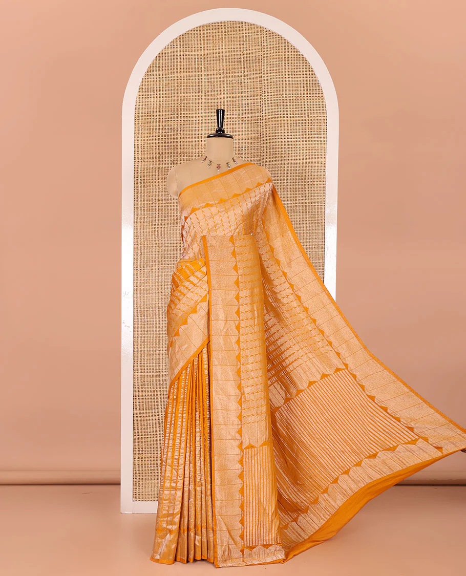 Mustard zari geometric fancy crepe saree, temple zari border, zari striped pallu, and a matching buttas woven blouse