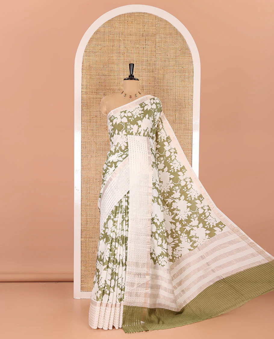 Olive green silhouette-style floral discharge printed Assam silk saree, contrast traditional zari border of rudraksham motifs, zari striped pallu, and a floral printed blouse