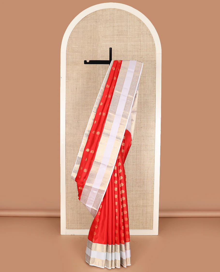 Orange arumbu manga buttas Vasundhara silk saree with contrast rettai pettu border of salngai, diamond, and kodi visiry designs, and intricate pallu