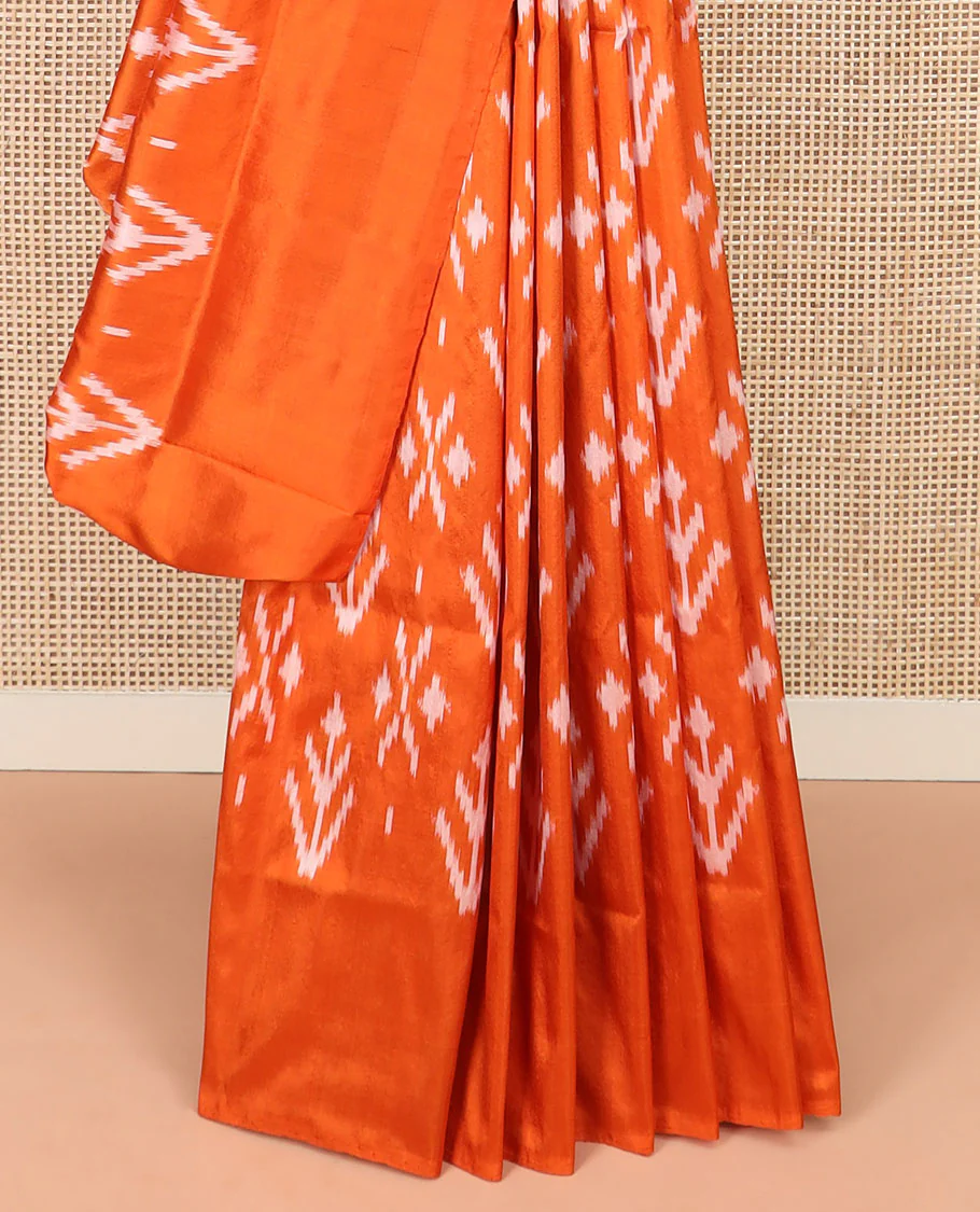Orange Ikkat Silk Saree Decked with Ikkat Buttas, Featuring a Subtle Plain Border, Complemented by a Pallu Woven in an Ogee Pattern with Ikkat Texture - Image 4