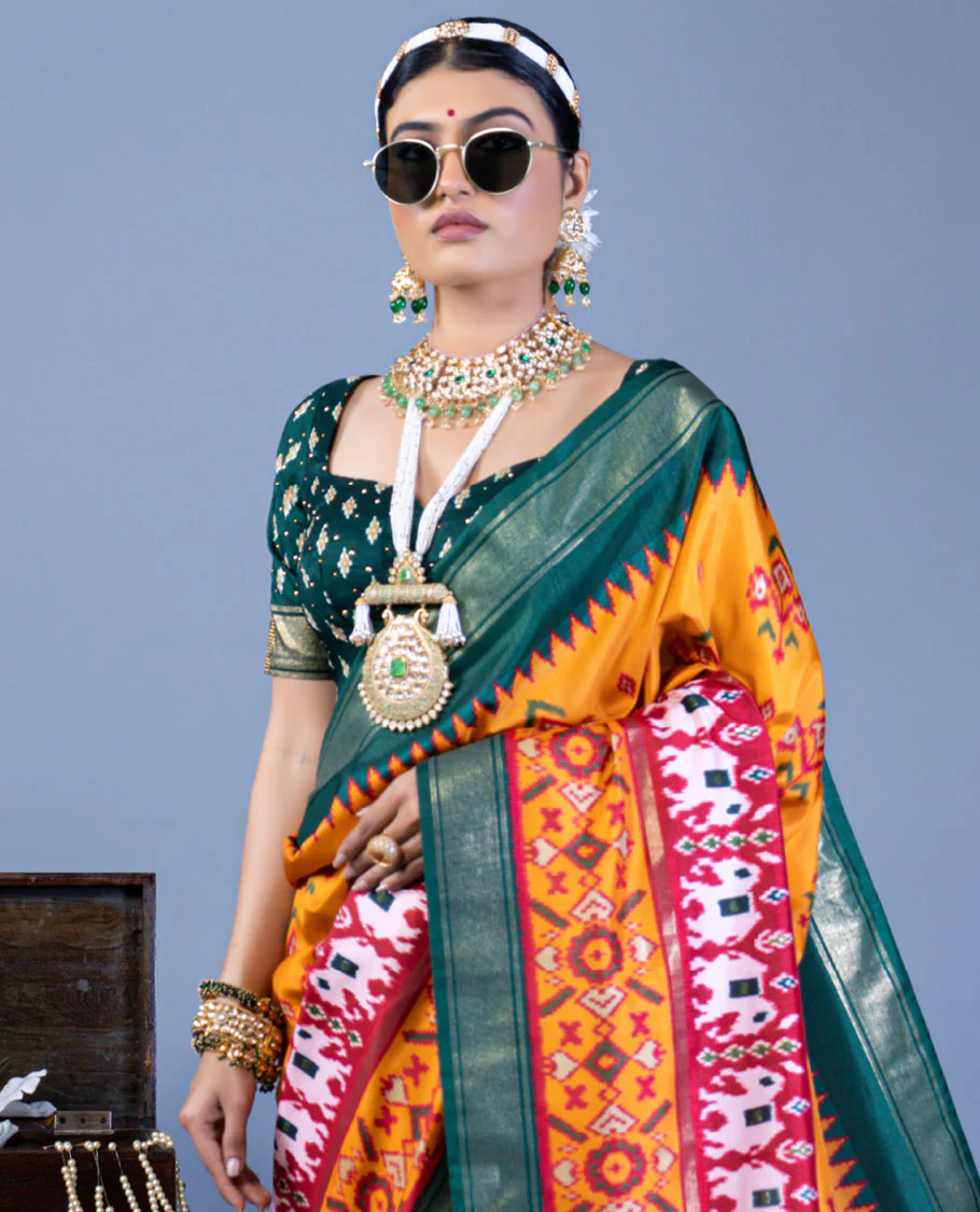 Orange patola floral motifs designer saree, contrast temple border, and patola printed pallu - Image 2