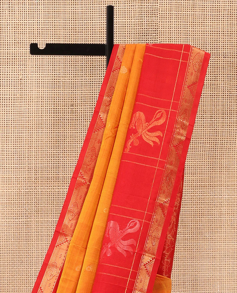 Orange Uppada Silk Saree Highlighted with Floral Buttas, Captivating Contrast Border of Traditional Zari Motifs and Peacock Motifs, Pallu Depicting Floral Jaal Design, and Paired with a Contrast Zari-Bordered Blouse - Image 3