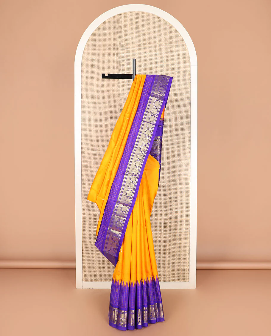 Orange zari buttas Kanchipuram silk saree, contrast thazampoo rekku checked border of mayil, manga, banaras, and kodi visiry designs, and floral jaal pallu