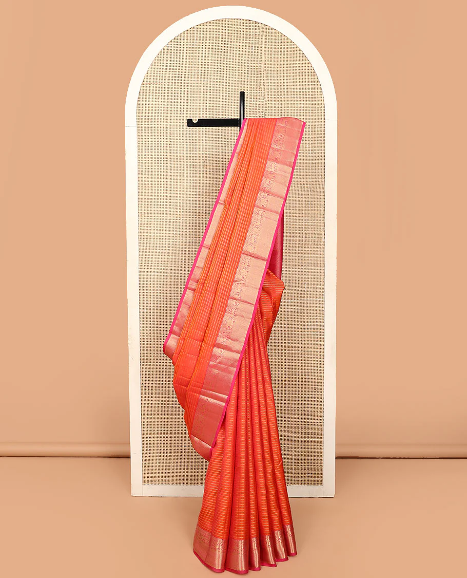 Orange zari striped Vasundhara silk saree, contrast border of thilakam mokku, yaanai, kuthirai, and kuyil kann designs, and jaal pallu