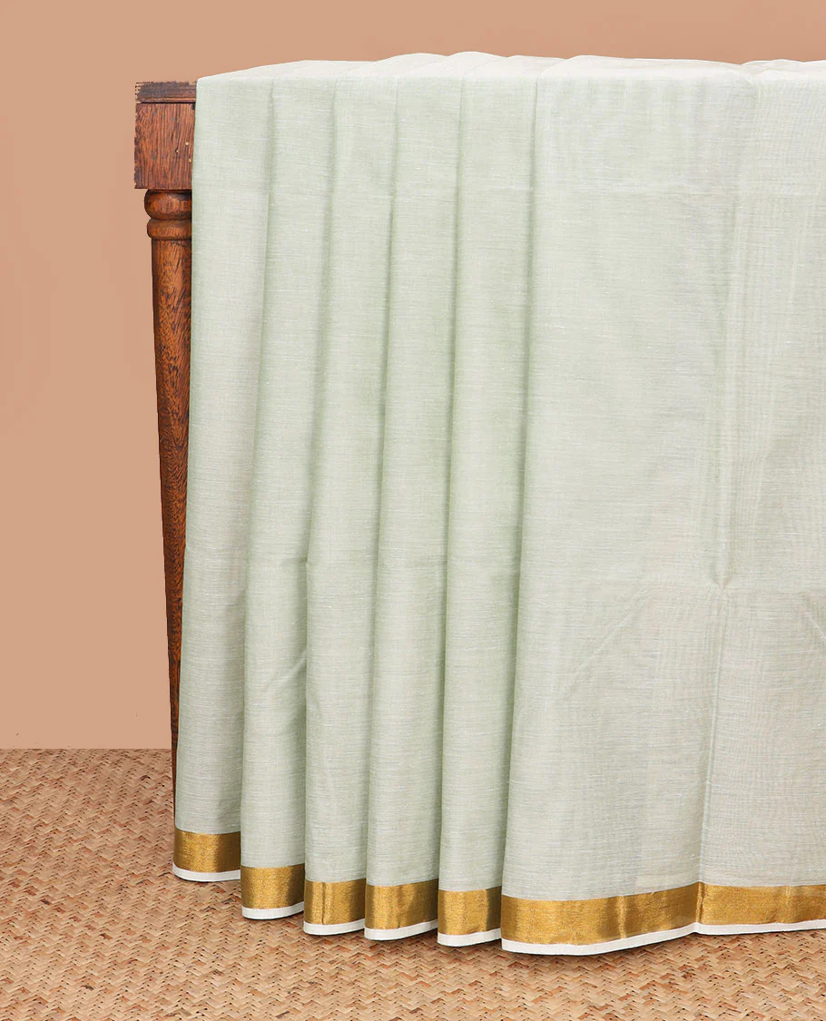 Pale green plain jute cotton saree, zari bavanji border, and striped pallu