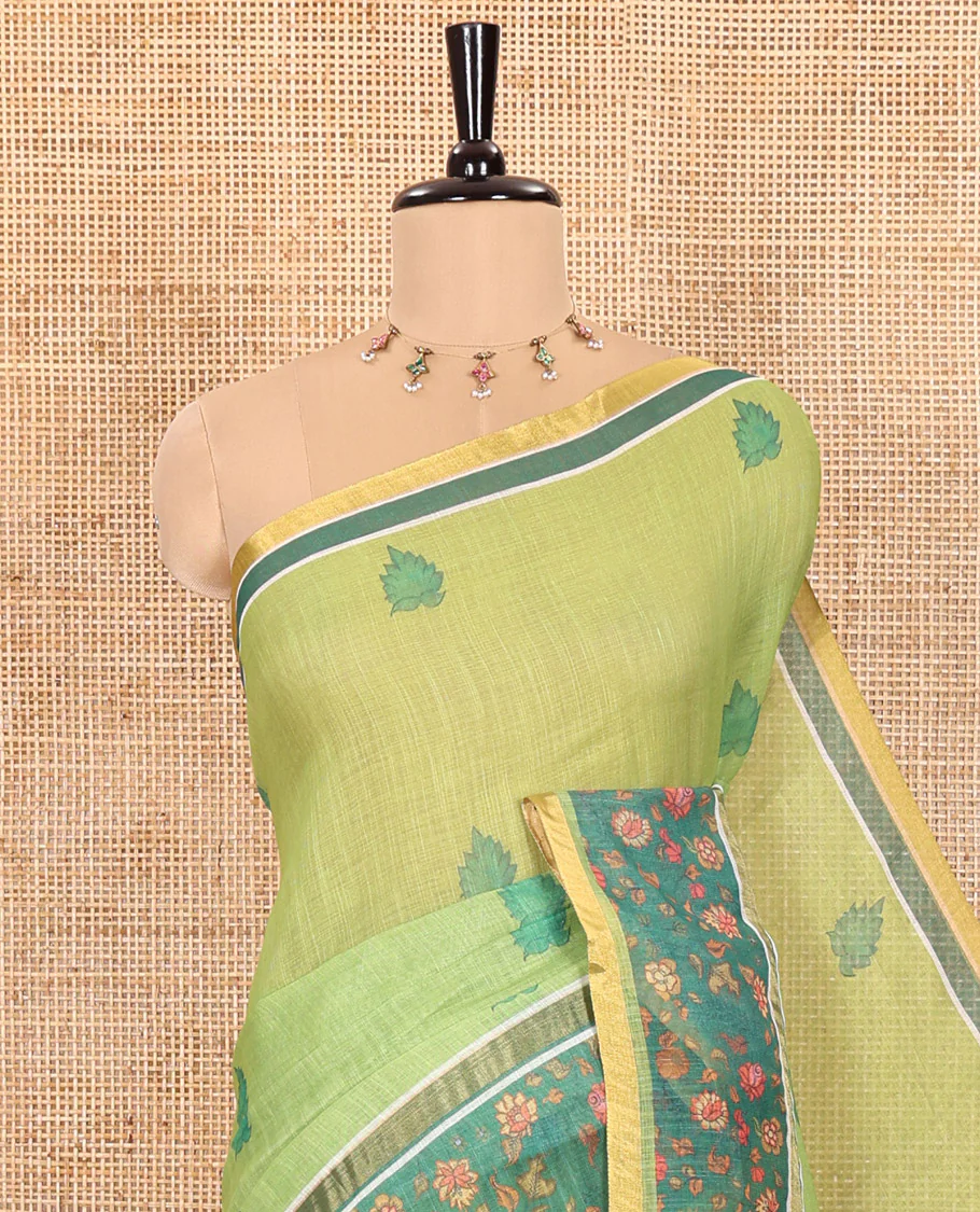 Parrot Green Linen Saree Highlighted with Leaf Motifs All Over Its Body, Complemented by a Contrast Floral Vine Printed Border, Pallu Mirrors the Floral Vine Print, and Paired with a Contrast Floral Printed Blouse - Image 2