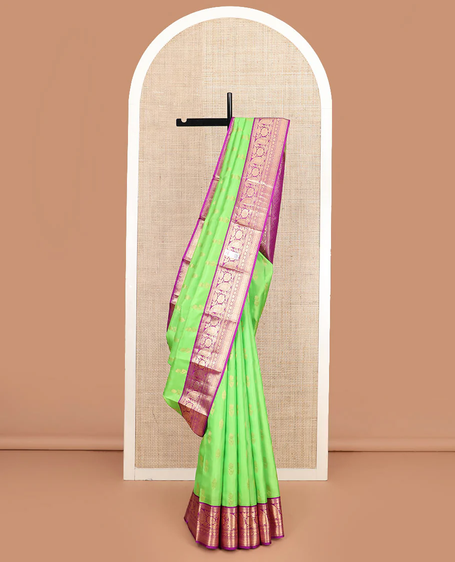 Parrot green zari buttas Vasundhara silk saree, contrast border of thilakam mokku, kathir, floral, manga, thilakam, neli, and diamond designs, and jaal pallu