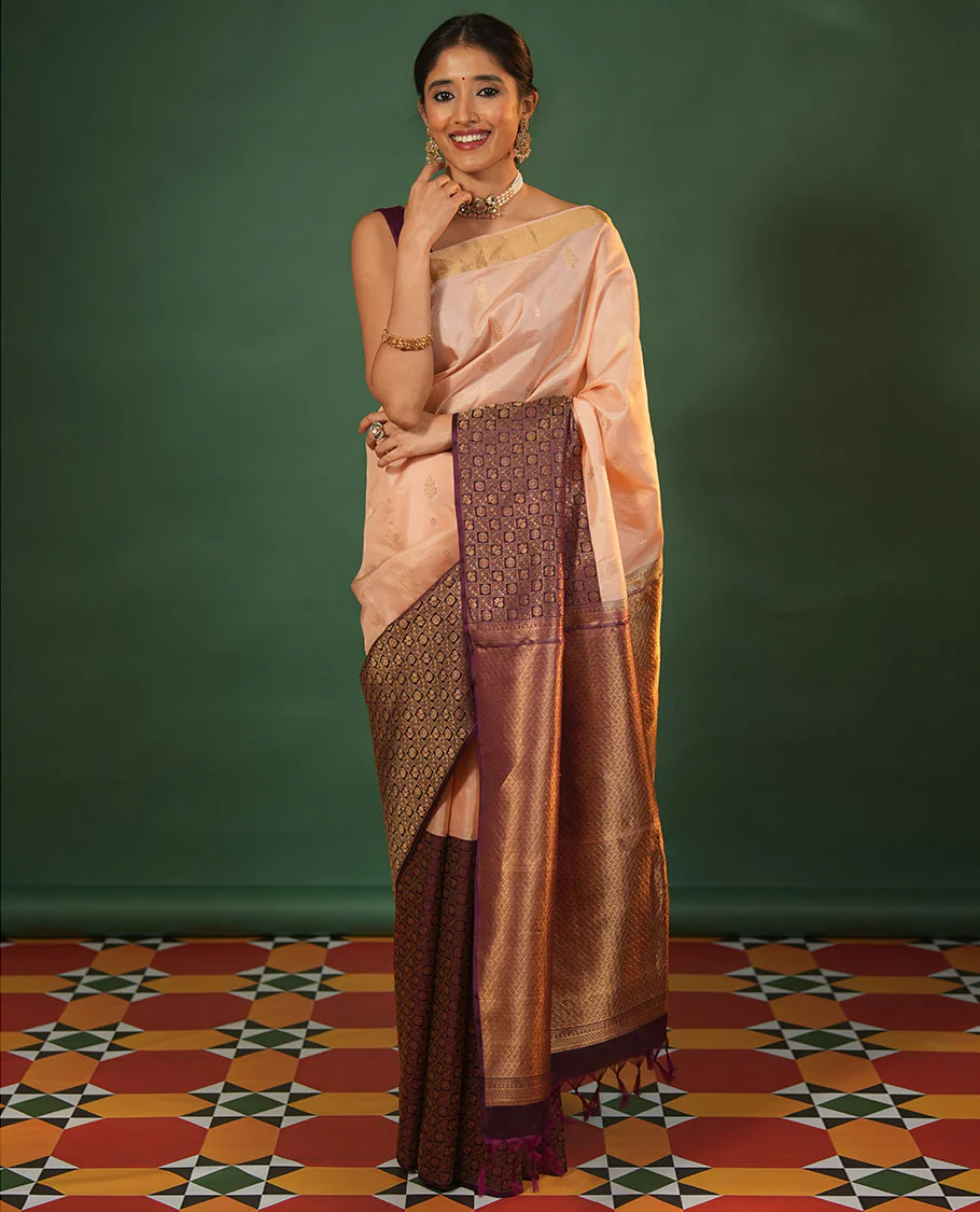 Peach floral zari buttas and skrit-border-style Vasundhara silk saree, contrast annam chakram butta enclosed checked border, and zari-rich jaal pallu