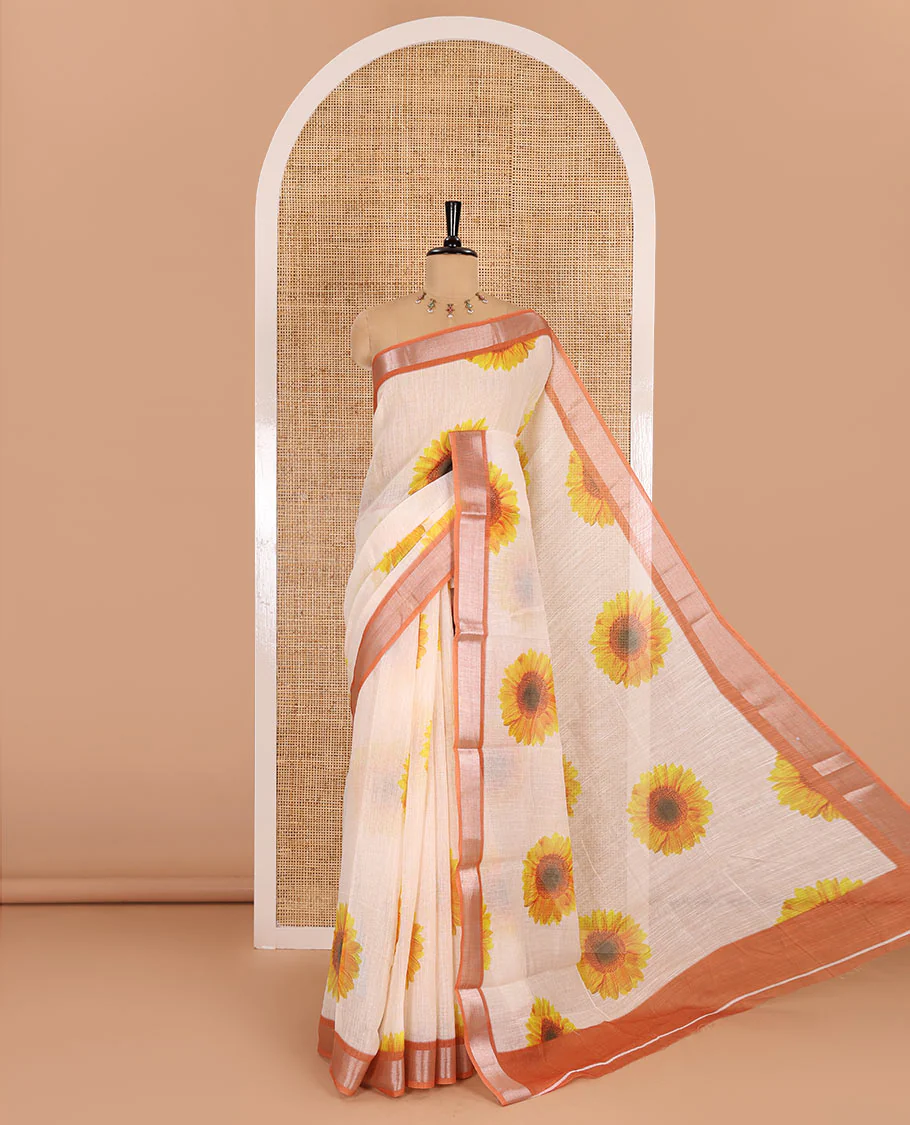 Peach sunflower motifs printed linen cotton saree, contrast zari border, sunflower motifs printed pallu, and contrast temple printed blouse