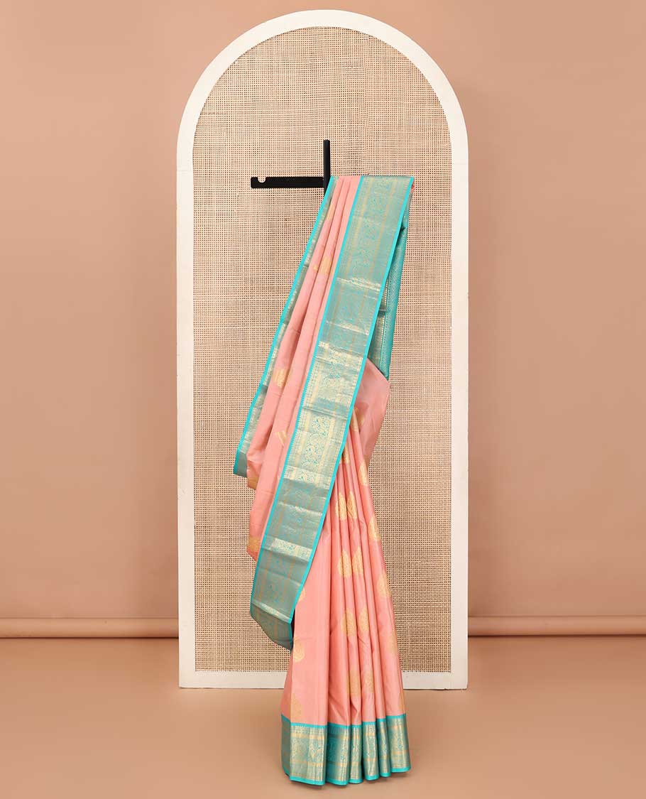 Peach thilakam buttas Vasundhara silk saree, contrast border of thilakam,muthu,poun, and mayil, and pallu of jaal design