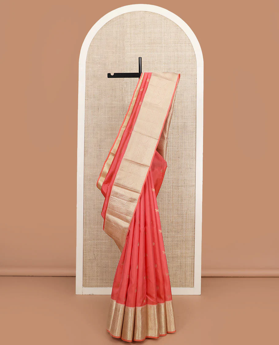 Peach zari buttas Vasundhara silk saree, contrast border of thilakam mokku, muthu, rudraksham, mayil kann, and manga designs, and jaal pallu