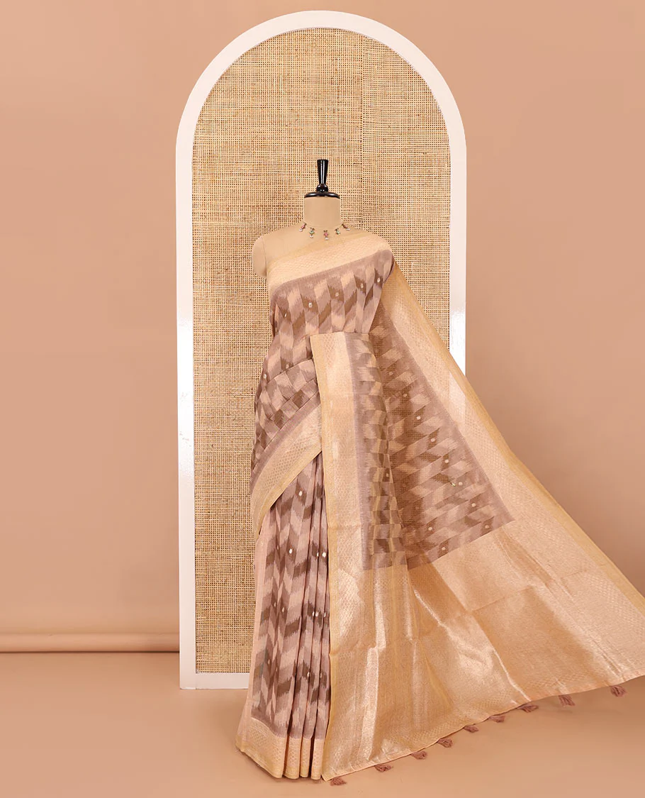 Peach zig-zag style ikkat design with buttas Munga cotton saree, zari jacquard blouse, ogee patterned pallu, and a contrast border of thread and zari buttas