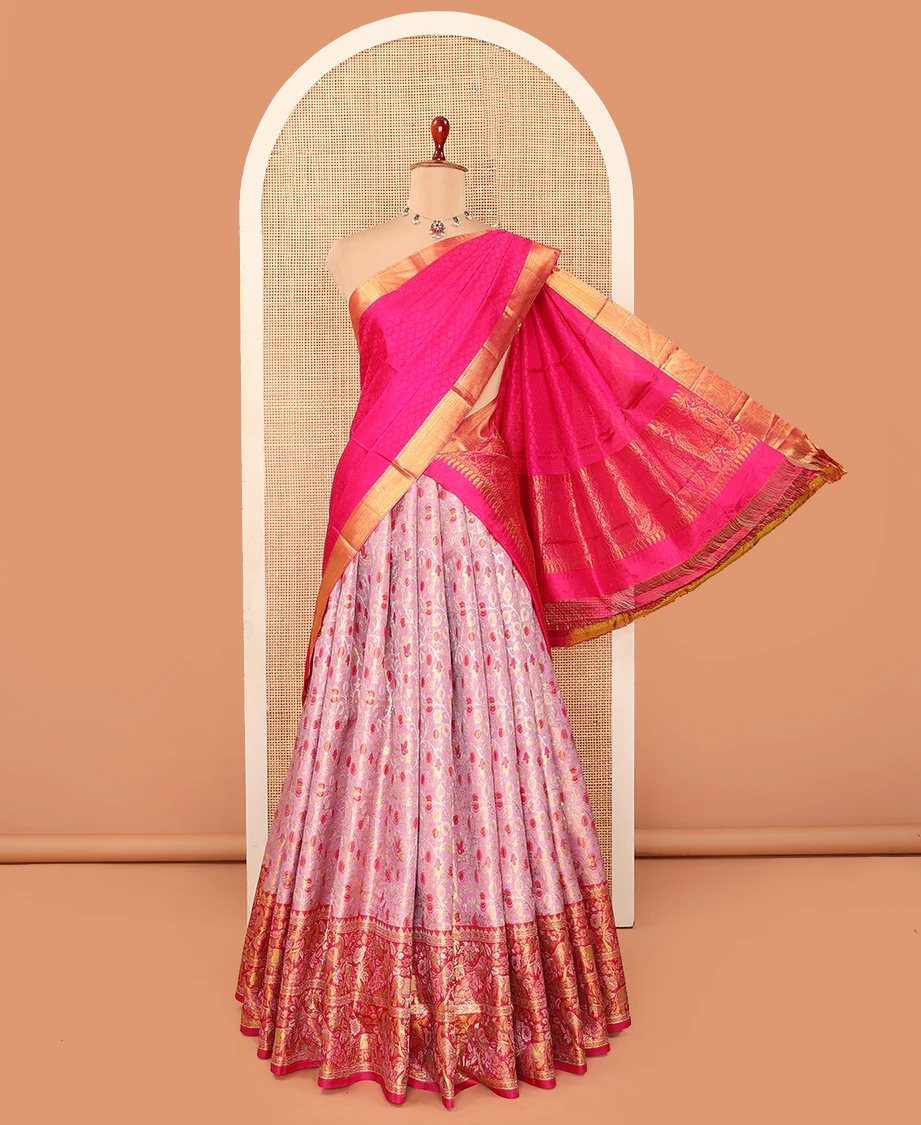 Pink Pure Silk Half-Saree Prettified with Floral Jaal Jacquard Design on Its Skirt, Complemented by a Contrast Meenakari Border Featuring Mayil and Yaanai Designs, Comes with a Contrast Jacquard Blouse and a Dhavani of Manga Designs