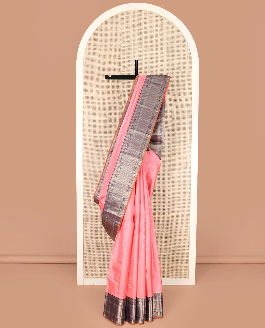 Pink Vasundhara Silk Saree Bedecked with Zari Buttas, Highlighted with a Contrast Border of Rekku, Muthu, Neli, and Mayil Poun Designs, Zari Gleamed Up Pallu of Ogee Patterns, and Paired with a Contrast Blouse
