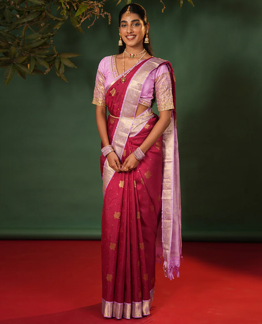 Pink yaanai and mayil buttas Vasundhara silk saree, contrast border of muthu, kathir, mayil, and yaanai designs, and diagonal striped pallu