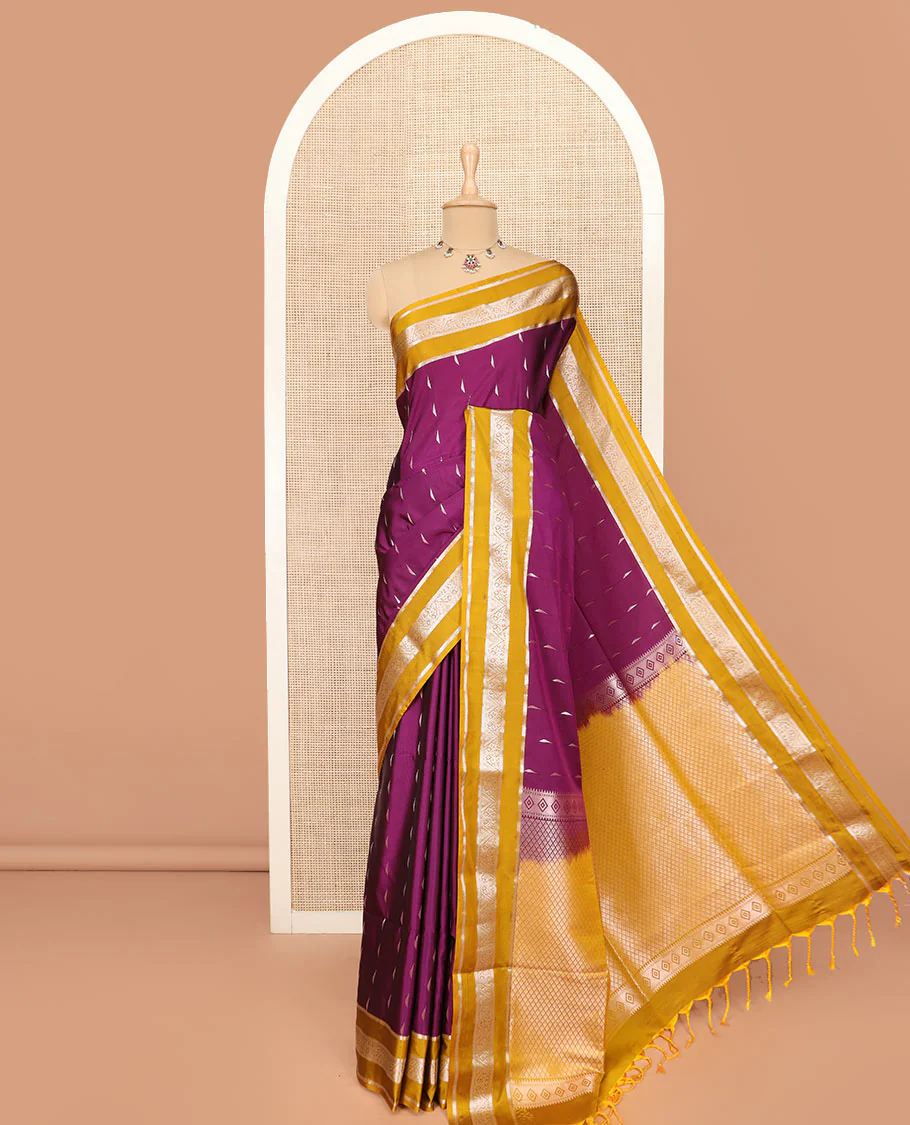 Purple Semi-Soft Silk Saree Ornamented with Zari Buttas Woven Across Its Body, Complemented by a Contrast Varisai Pettu Traditional Zari Border, Grandly Decked Up Pallu of Jaal Designs, and Paired with a Contrast Blouse