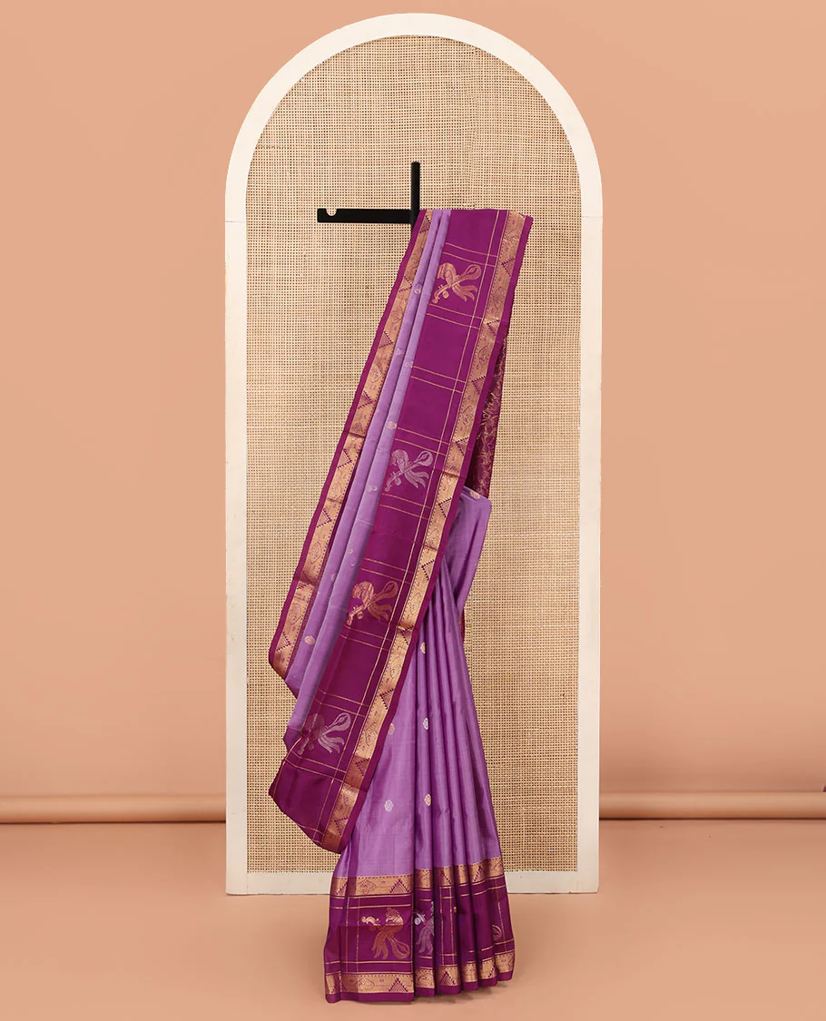 Purple Uppada Silk Saree Elevated with Floral Buttas, Captivating Contrast Border of Traditional Zari Motifs and Peacock Motifs, Pallu Depicting Floral Jaal Design, and Paired with a Contrast Zari-Bordered Blouse
