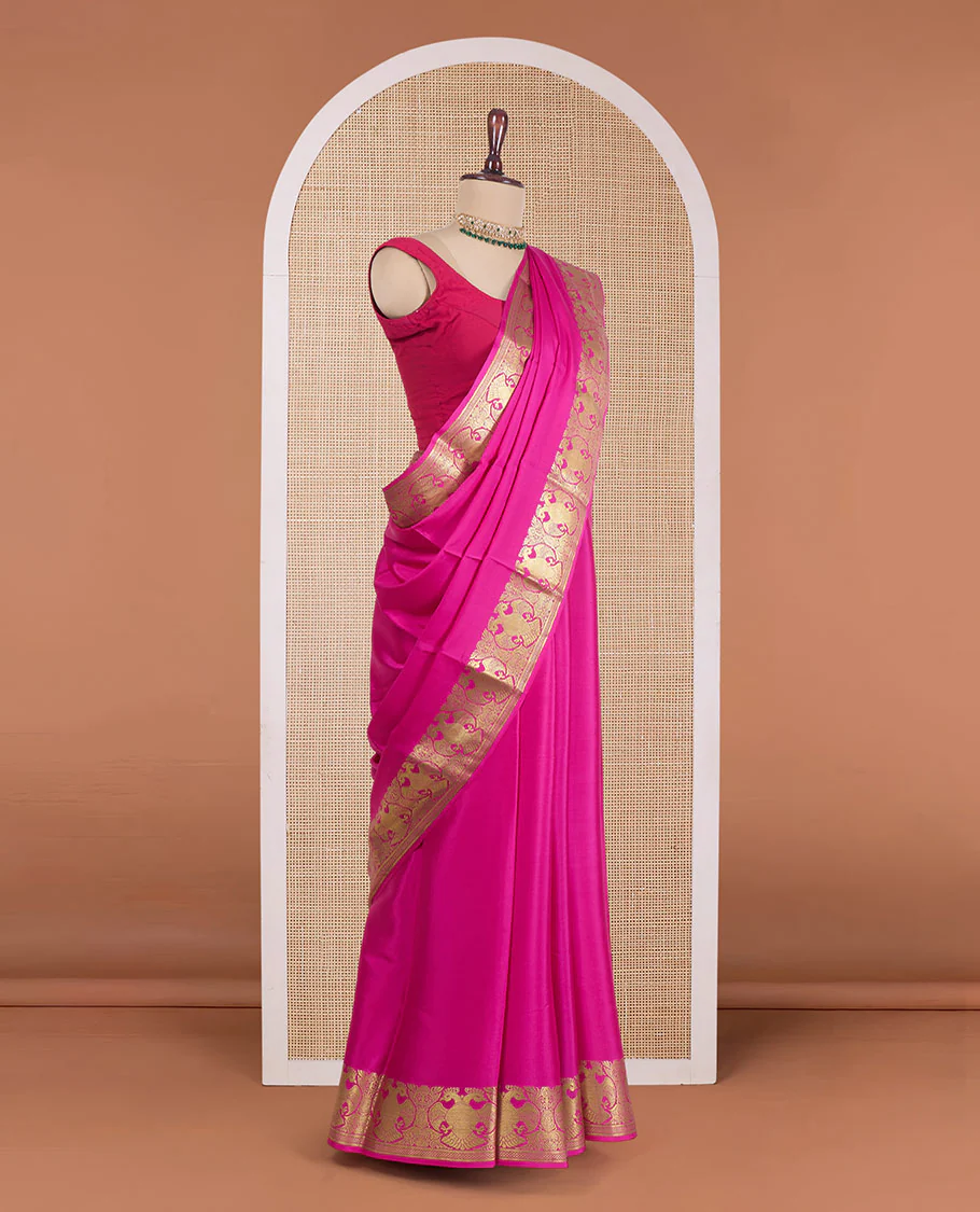 Rani pink plain Mysore silk saree, zari border of two-headed eagle motifs, and pallu steeped with two-headed eagle motifs