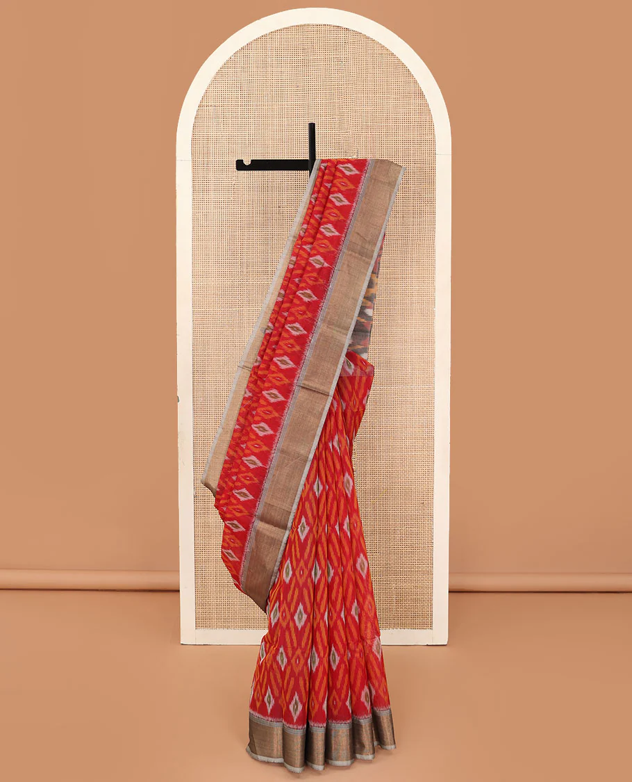Red buttas and diamond patterned silk cotton saree, contrast bavanji border, and pallu of ikkat floral design
