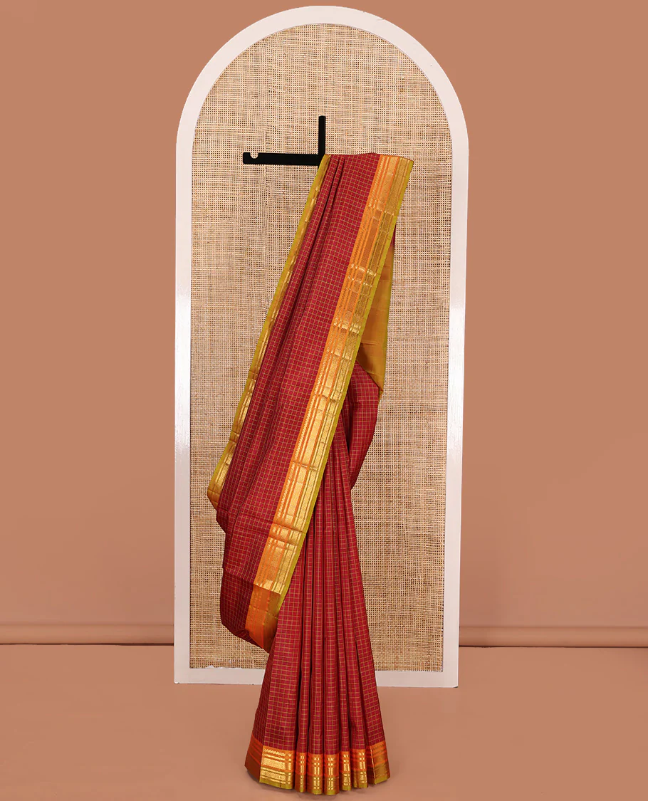 Red checked Kanchipuram silk saree, contrast border of salngai, kathir, mayil kann, and rudraksham designs, and zari striped pallu